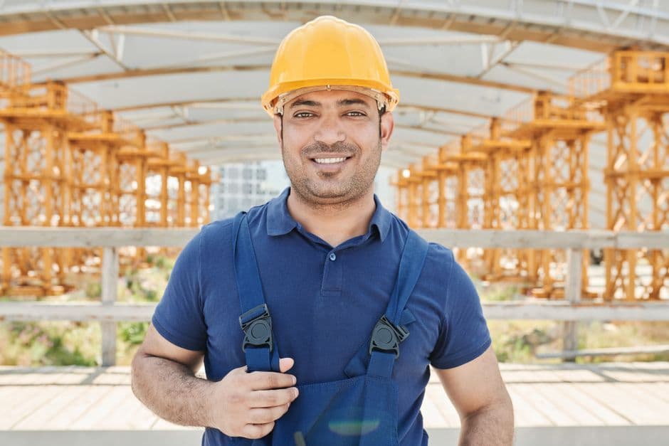 A construction worker in a hard hat on a building site