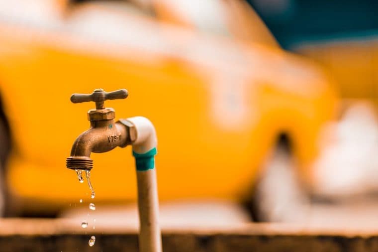 Clean water running from a kitchen tap into a sink