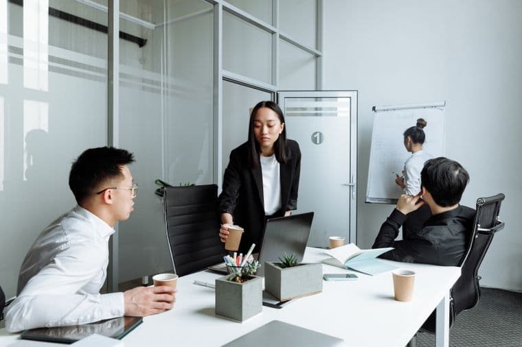 Colleagues around a meeting table in a modern office
