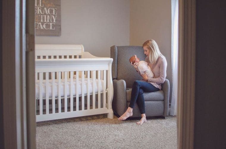 A newborn baby resting in a softly lit nursery