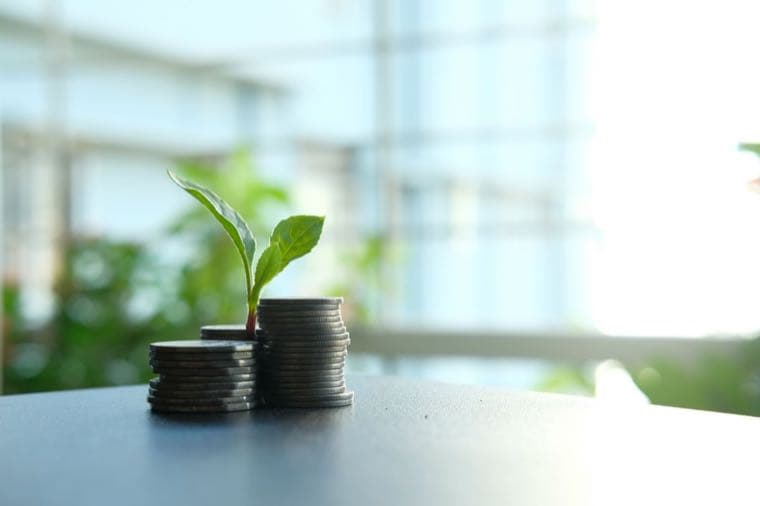 Australian coins stacked in growing piles, representing ETF income