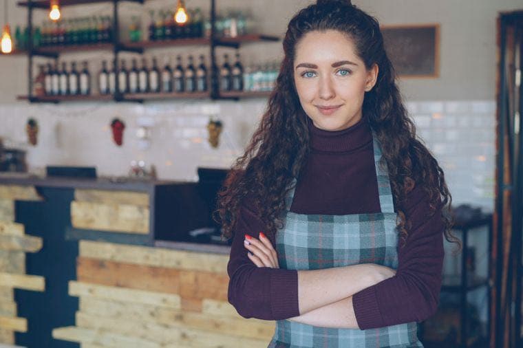 A small business owner standing in her cafe