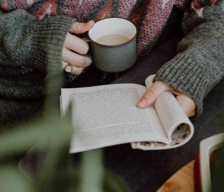 A calm hand resting beside a wallet, suggesting a considered pause before spending