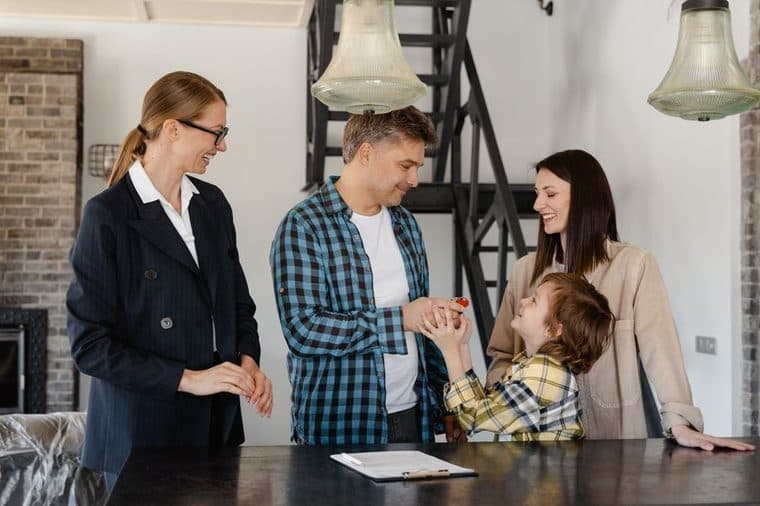 A young couple holding the keys to their first new home in South Australia