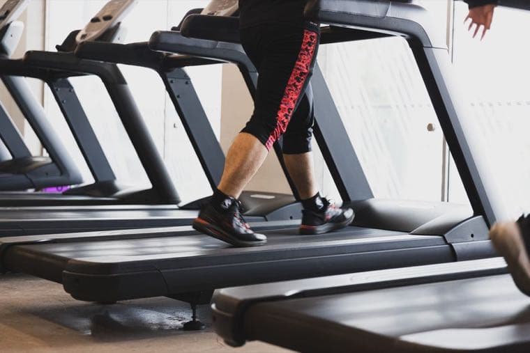 A person walking on a treadmill, a visual metaphor for the hedonic treadmill