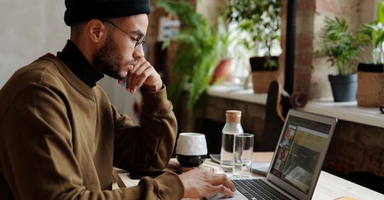 A freelancer working at a laptop at home