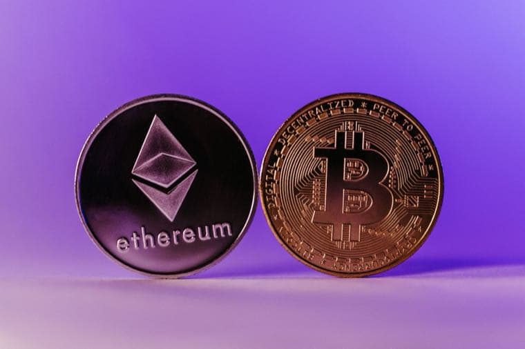 An Ethereum coin and a Bitcoin coin on a purple background