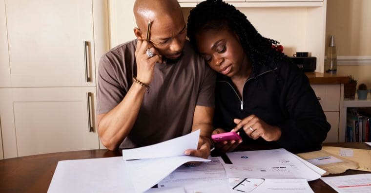 Household bills and a calculator on a table