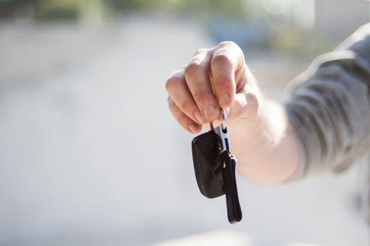 A set of car keys being handed over