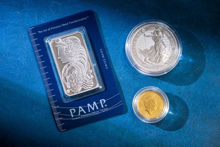 Silver bullion bars and coins stacked together
