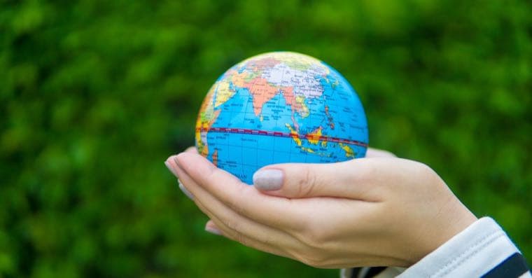 A globe surrounded by green leaves symbolising ethical global investing