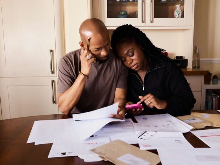 A family managing their budget at the kitchen table