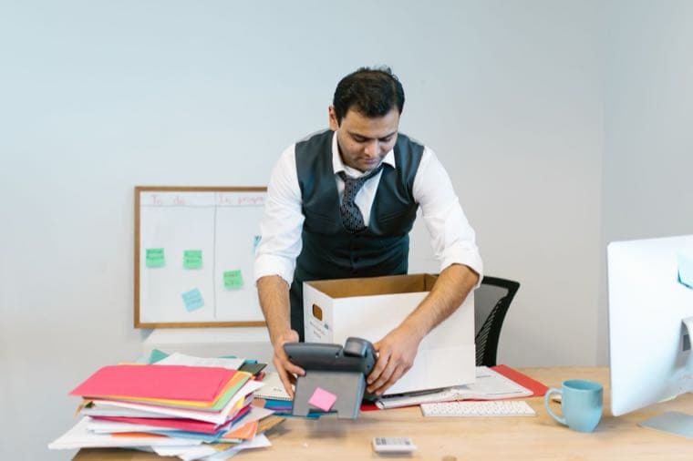 A person packing up their desk, representing resigning and notice periods in Australia