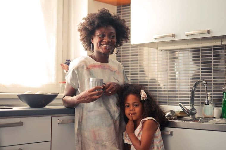 A parent and child together in a kitchen at home