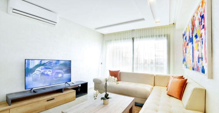 A bright rental living room full of a tenant's own belongings in Australia