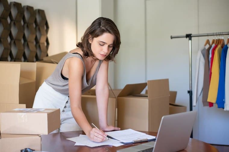 Small business owner working from home, weighing up sole trader vs company