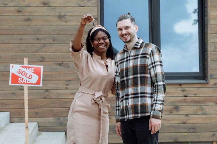 A couple holding keys to their first home, representing stamp duty concessions for first home buyers