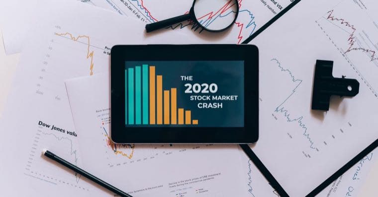 A tablet showing a stock market crash with falling charts