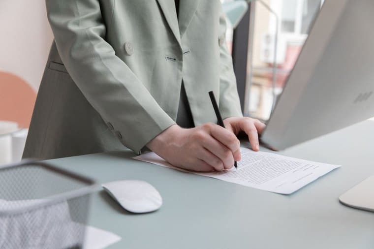 A new employee completing paperwork at a desk