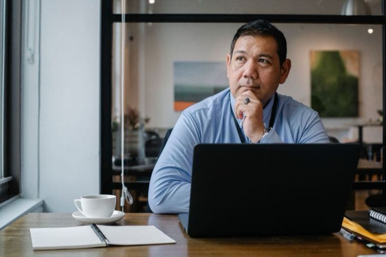 A calm person planning at a desk with a notebook, deciding what to do with a lump sum
