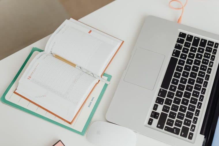 A desk calendar and laptop used to plan tax time