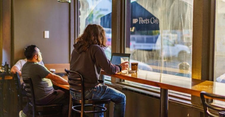 A backpacker checking finances on a laptop while travelling in Australia