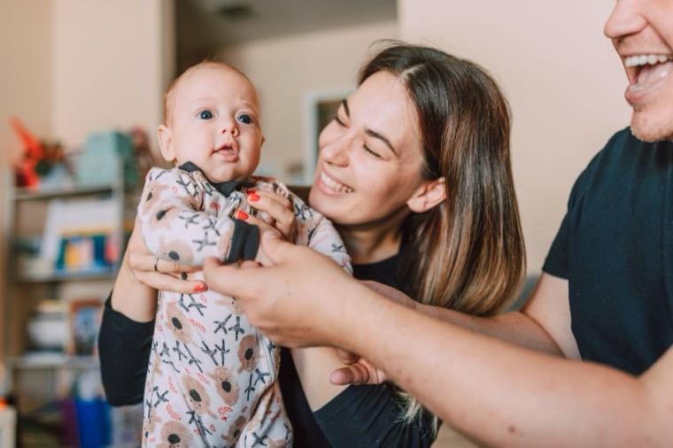 Parents holding their newborn baby, representing parental leave in Australia